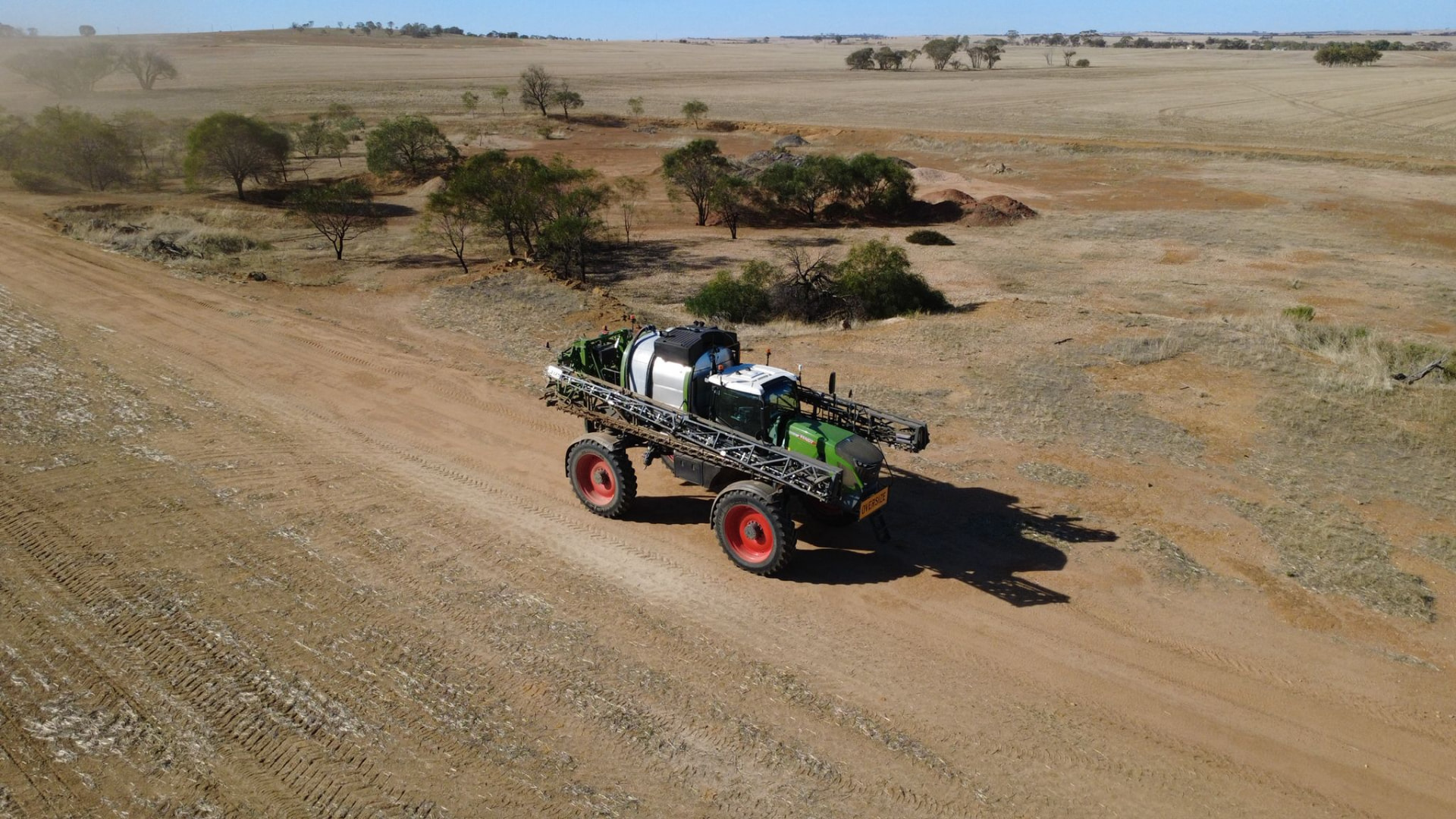 Self-propelled boom sprayer travelling a farm track through WA cropping country